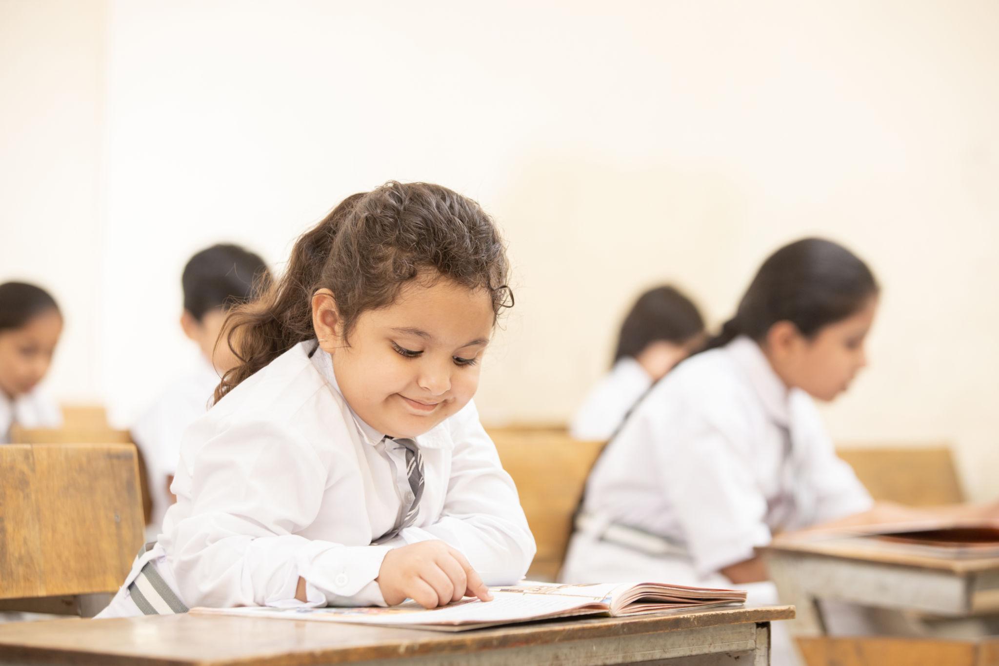 Class 3 student studying at home with books