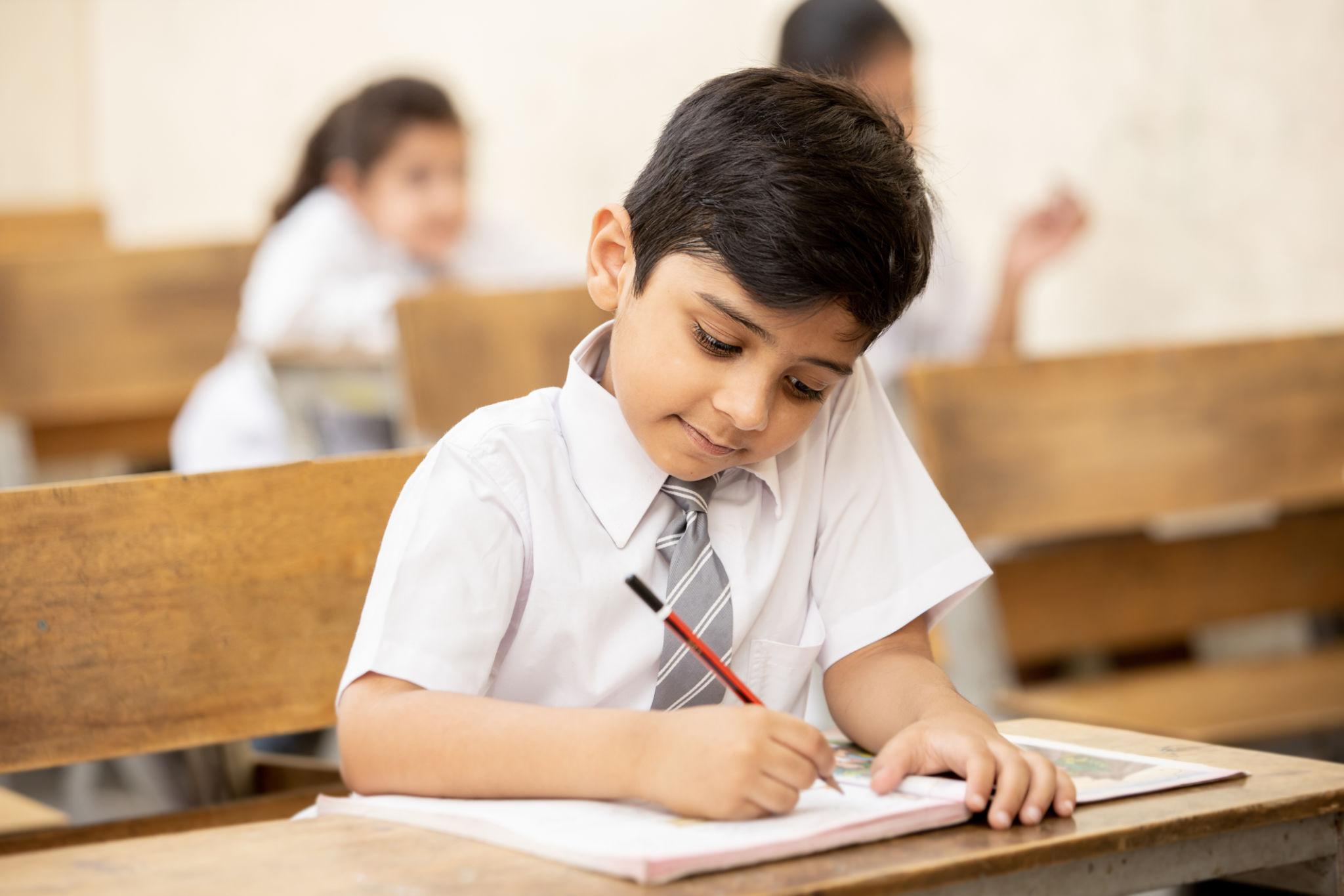 Indian Class 1 child learning and doing school work